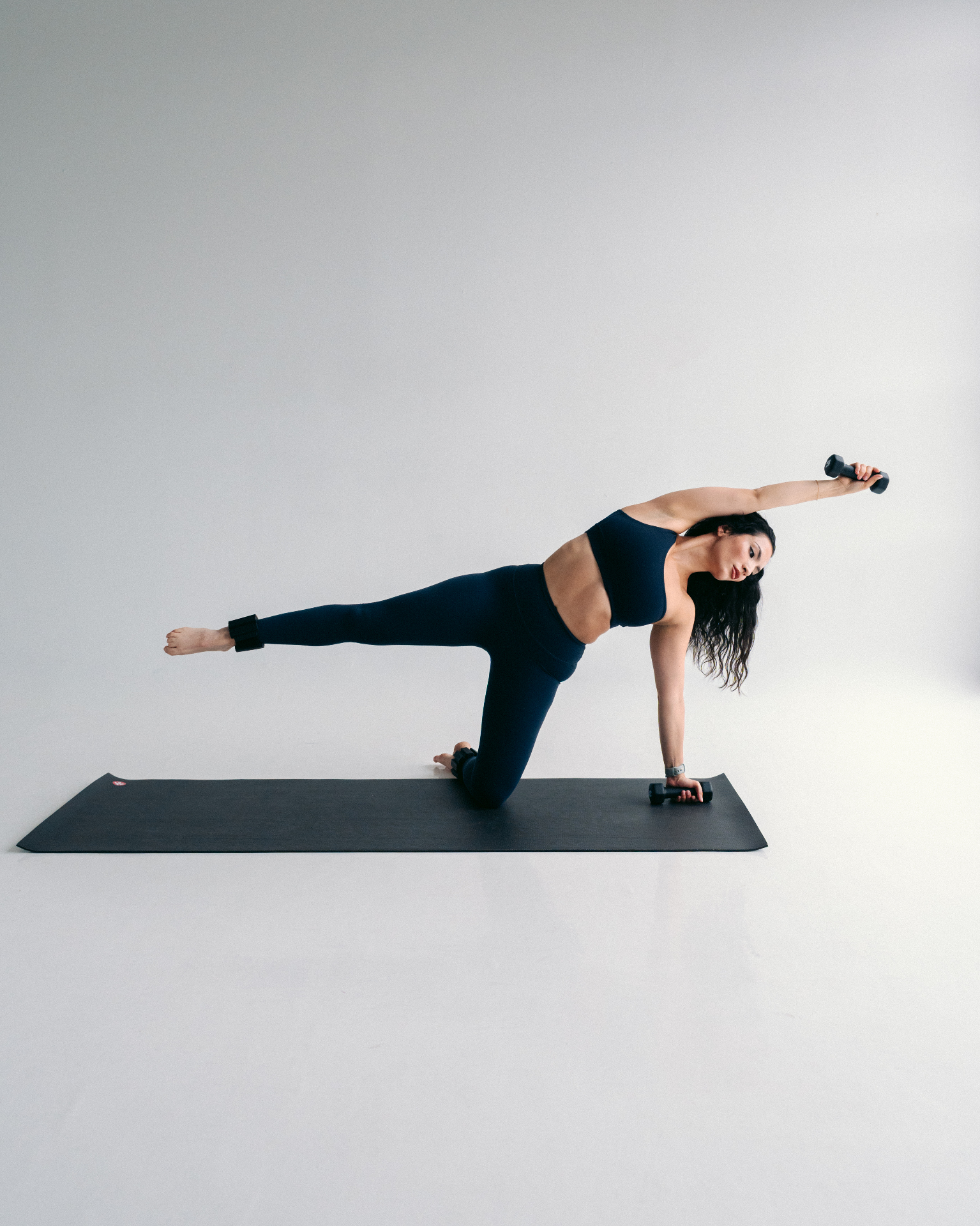 Two Linked Fitness members training with dumbbells